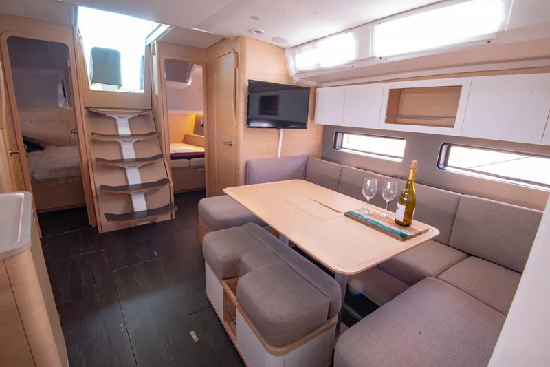 Slide: The Image of Luxurious interior of 2024 Dufour 41 yacht with modern seating and dining area. - 17