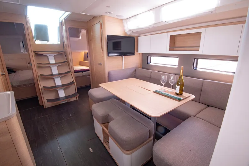 Slide: The Image of Modern interior of 2024 Dufour 41 yacht with cozy seating and dining area. - 2
