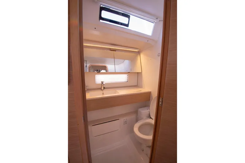 Slide: The Image of 2024 Dufour 41 yacht bathroom with modern fixtures and natural lighting. - 20
