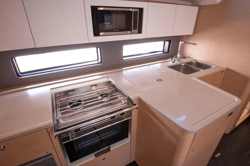 Slide: The Image of Modern kitchen in 2024 Dufour 41 yacht with stove, sink, and microwave. - 21
