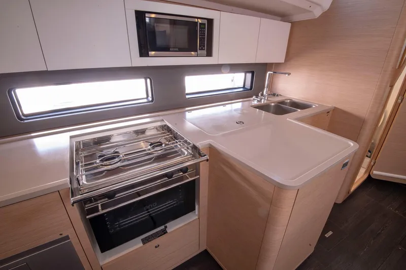 Slide: The Image of Modern kitchen in 2024 Dufour 41 yacht with stove, microwave, and dual sink. - 22