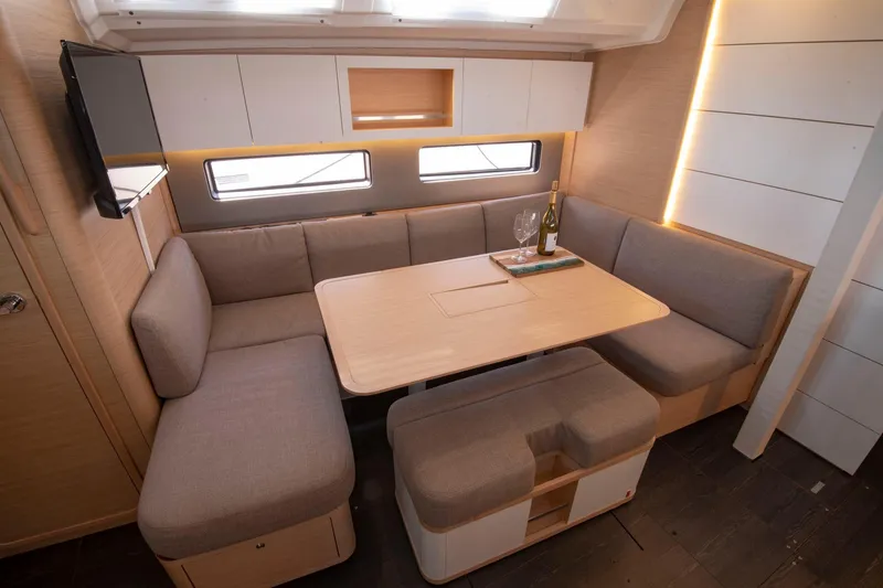 Slide: The Image of Modern interior of 2024 Dufour 41 yacht with cozy seating and dining area. - 23