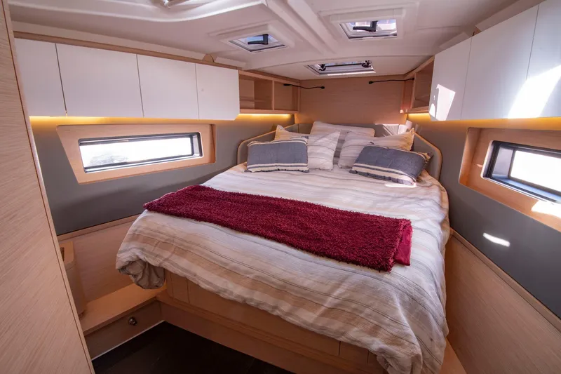 Slide: The Image of Luxurious cabin interior of 2024 Dufour 41 yacht with cozy bedding and modern design. - 5