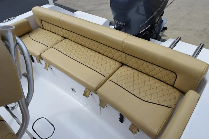 Slide: The Image of 2019 Sportsman Heritage 211 Center Console with tan quilted seating and outboard motor. - 11