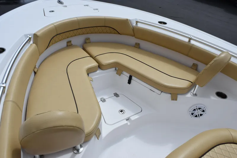 Slide: The Image of 2019 Sportsman Heritage 211 Center Console boat with tan cushioned seating area. - 12
