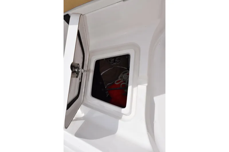 Slide: The Image of 2019 Sportsman Heritage 211 Center Console storage compartment with open hatch. - 18