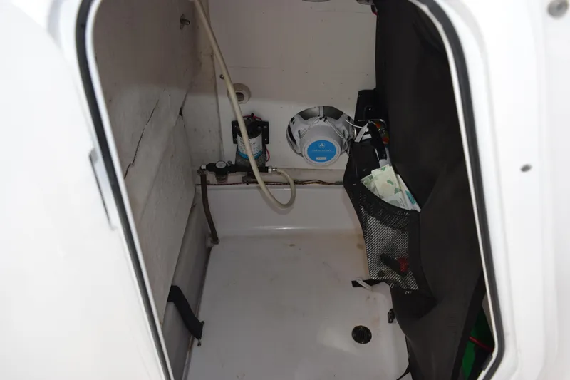 Slide: The Image of 2019 Sportsman Heritage 211 Center Console storage compartment with speaker and accessories. - 19