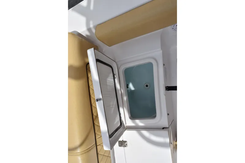 Slide: The Image of 2019 Sportsman Heritage 211 Center Console boat interior with open storage compartment. - 21