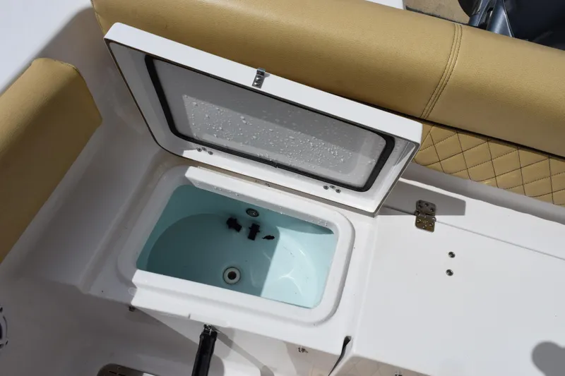 Slide: The Image of Open storage compartment on 2019 Sportsman Heritage 211 Center Console boat. - 22