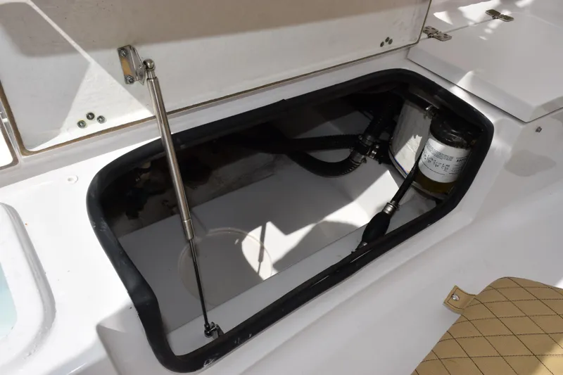Slide: The Image of Open storage compartment in 2019 Sportsman Heritage 211 Center Console boat. - 23