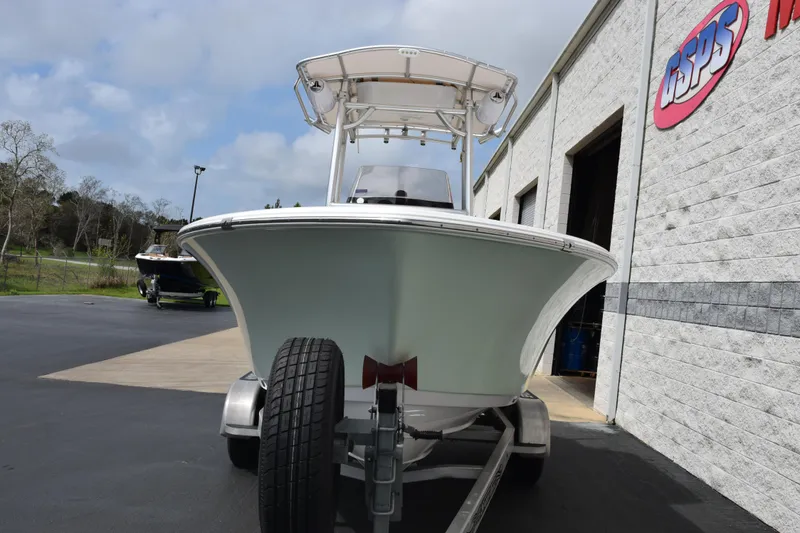 Slide: The Image of 2019 Sportsman Heritage 211 Center Console boat on trailer outside a building. - 3