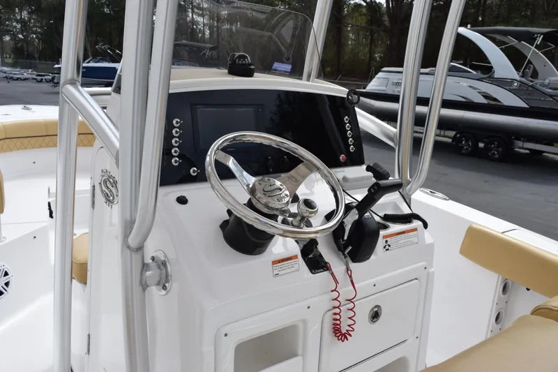 Slide: The Image of 2019 Sportsman Heritage 211 Center Console boat dashboard with steering wheel and controls. - 7