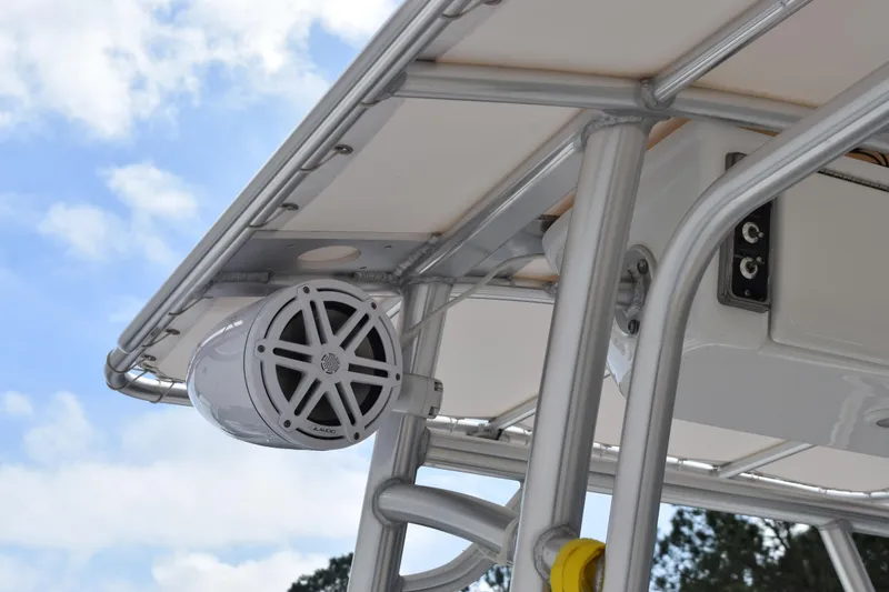 Slide: The Image of 2019 Sportsman Heritage 211 Center Console boat with mounted speaker and metal framework. - 9