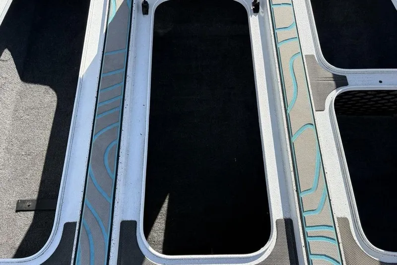 Slide: The Image of 2022 Xpress X19 Pro boat storage compartments with blue accents and textured surfaces. - 13