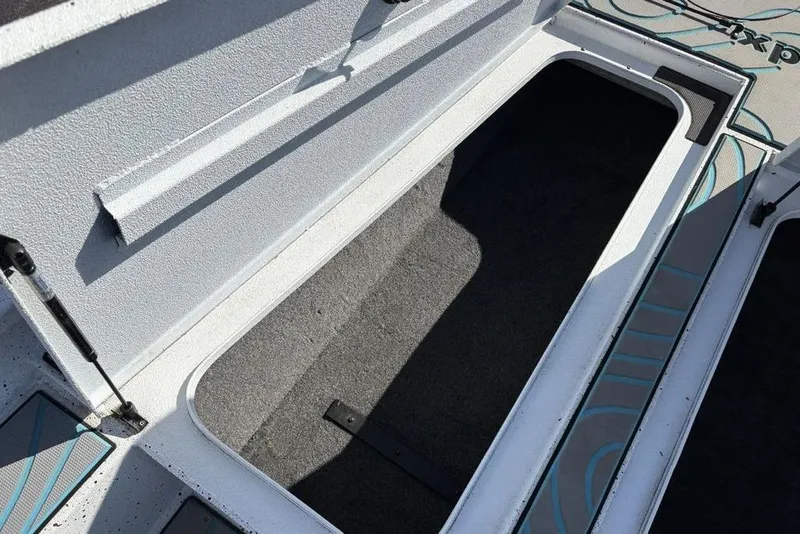 Slide: The Image of Open storage compartment in 2022 Xpress X19 Pro boat, featuring a spacious interior. - 14