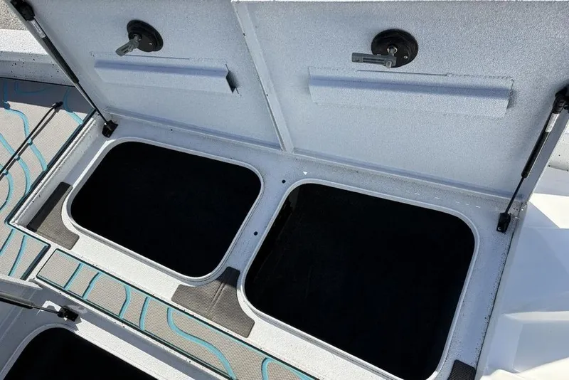 Slide: The Image of Open storage compartments on 2022 Xpress X19 Pro boat deck. - 15