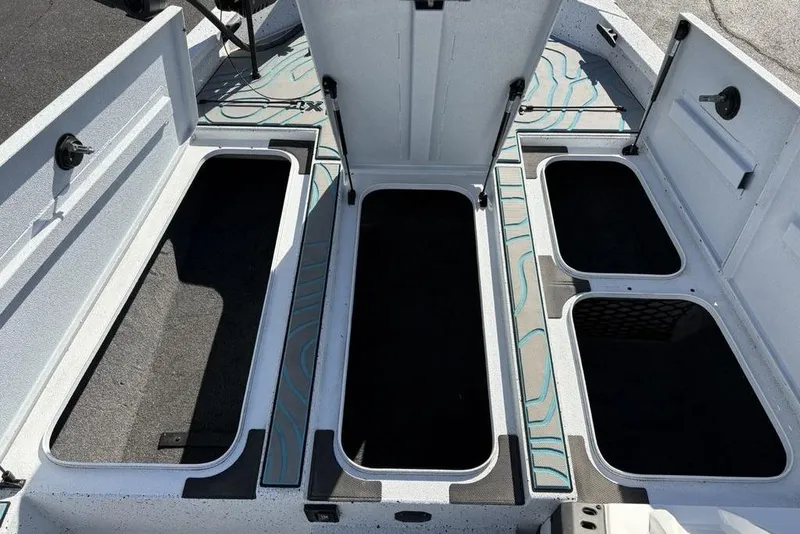Slide: The Image of Open storage compartments on a 2022 Xpress X19 Pro boat deck. - 16