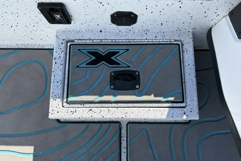 Slide: The Image of Xpress X19 Pro 2022 boat deck with speckled design and logo detail. - 18