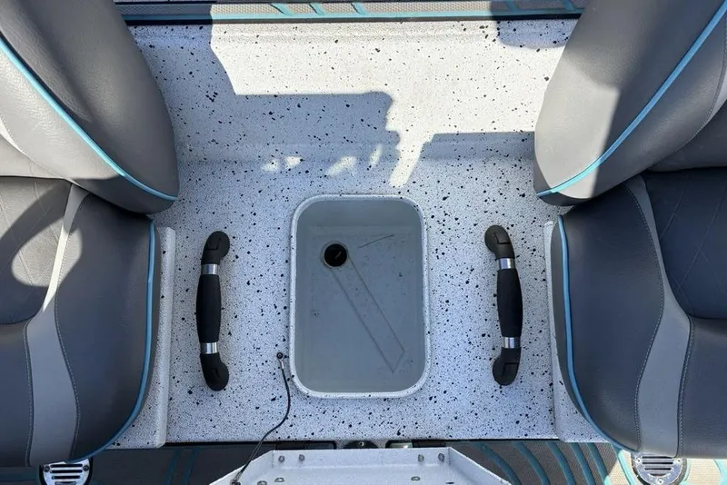 Slide: The Image of 2022 Xpress X19 Pro boat interior with gray seats and speckled flooring. - 19