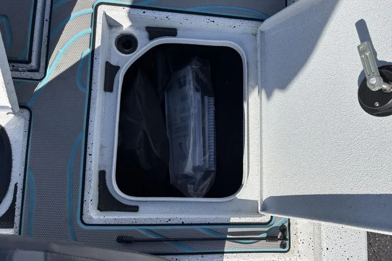 Slide: The Image of Open storage compartment on 2022 Xpress X19 Pro boat deck. - 25