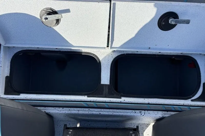 Slide: The Image of 2022 Xpress X19 Pro boat storage compartments with open lids, showcasing interior space. - 26