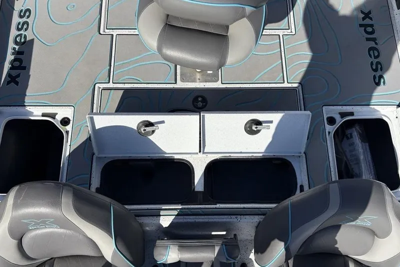 Slide: The Image of 2022 Xpress X19 Pro boat interior with storage compartments and seating. - 28