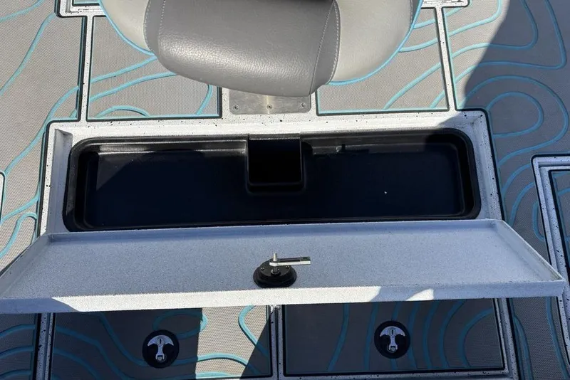 Slide: The Image of 2022 Xpress X19 Pro boat storage compartment with open lid and seat. - 30