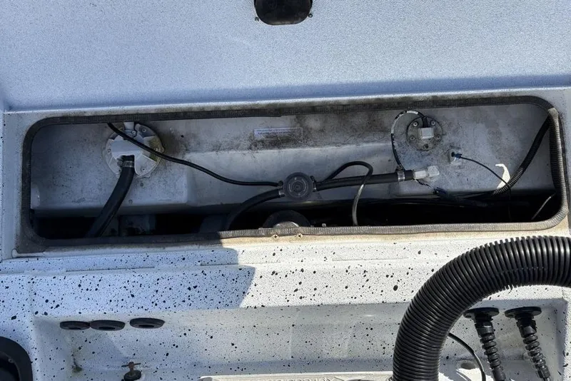 Slide: The Image of 2022 Xpress X19 Pro boat compartment with visible wiring and hoses. - 33