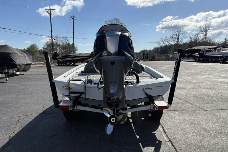 Slide: The Image of 2022 Xpress X19 Pro boat on trailer, rear view, parked outdoors. - 5