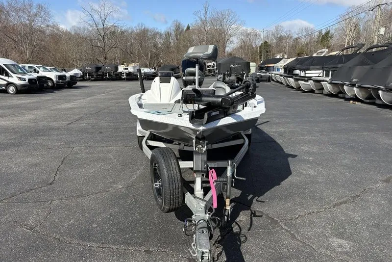 Slide: The Image of 2022 Xpress X19 Pro boat on trailer in parking lot, surrounded by vehicles. - 6