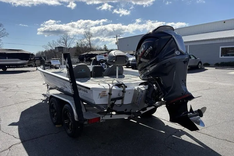 Slide: The Image of 2022 Xpress X19 Pro boat with powerful outboard motor in a parking lot. - 7