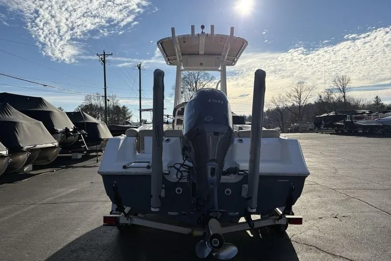 Slide: The Image of 2018 Tidewater 210 LXF boat with Yamaha 150 engine, parked outdoors under a sunny sky. - 11