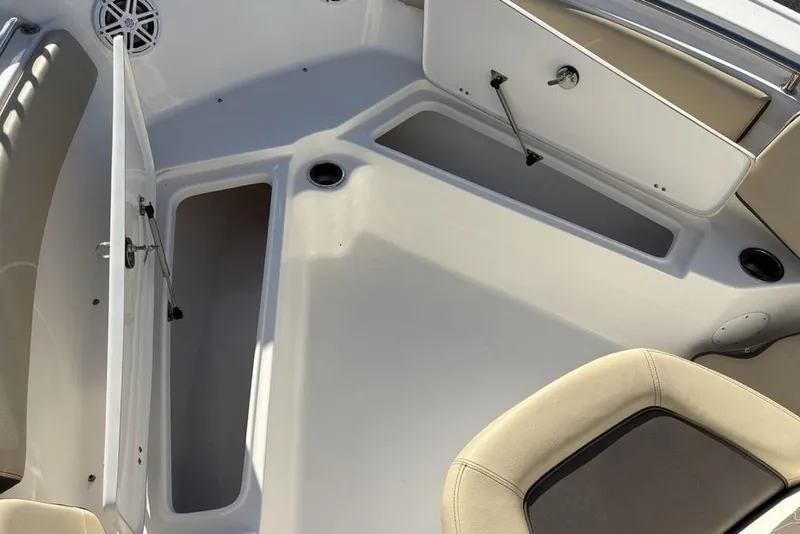 Slide: The Image of 2018 Tidewater 210 LXF boat interior with open storage compartments and seating. - 16