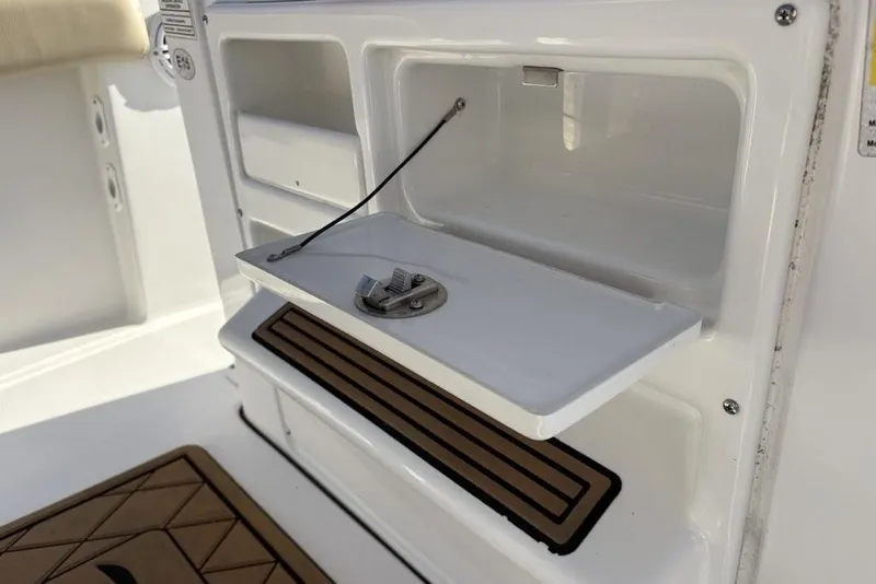 Slide: The Image of Tidewater 210 LXF 2018 boat, open storage compartment with lid. - 18