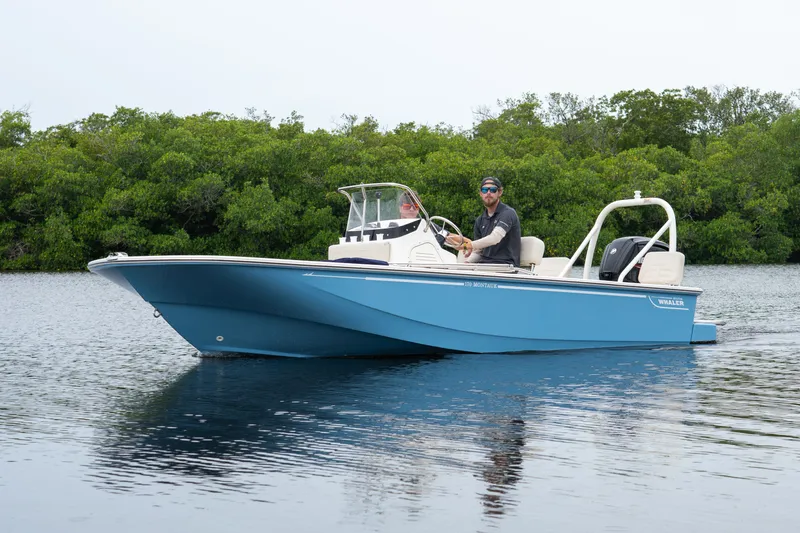 Slide: The Image of 2026 Boston Whaler 170 Montauk on calm water with green backdrop. - 10
