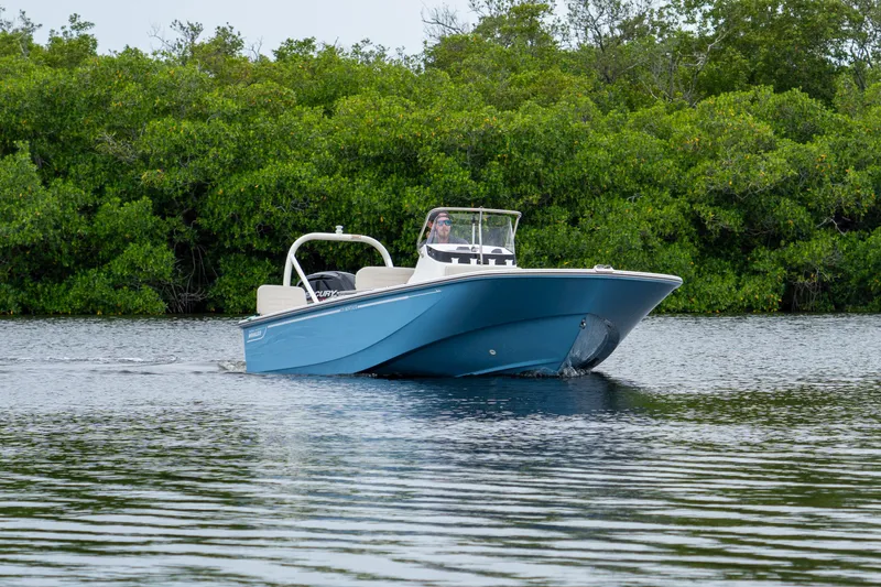 Slide: The Image of Boston Whaler 170 Montauk 2026 on calm water with green backdrop. - 13