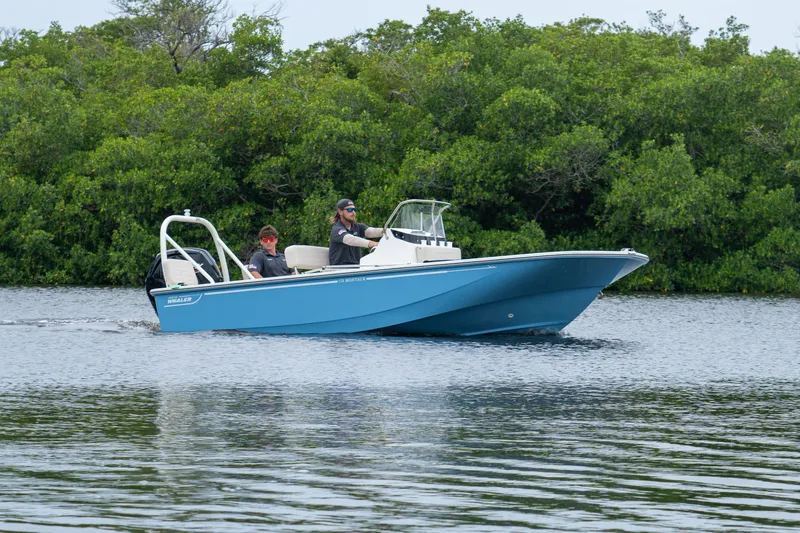 Slide: The Image of Boston Whaler 170 Montauk 2026 on calm water with green backdrop. - 2