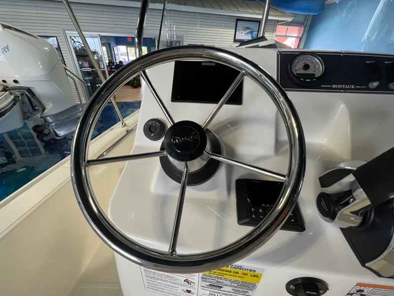 Slide: The Image of Steering wheel of Boston Whaler 150 Montauk 2026 boat. - 20