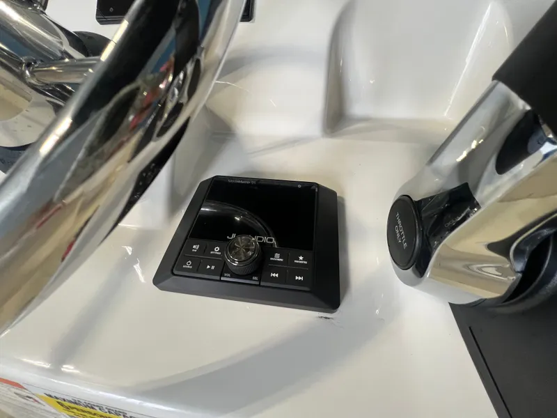 Slide: The Image of Boston Whaler 150 Montauk 2026 helm with audio control panel. - 22