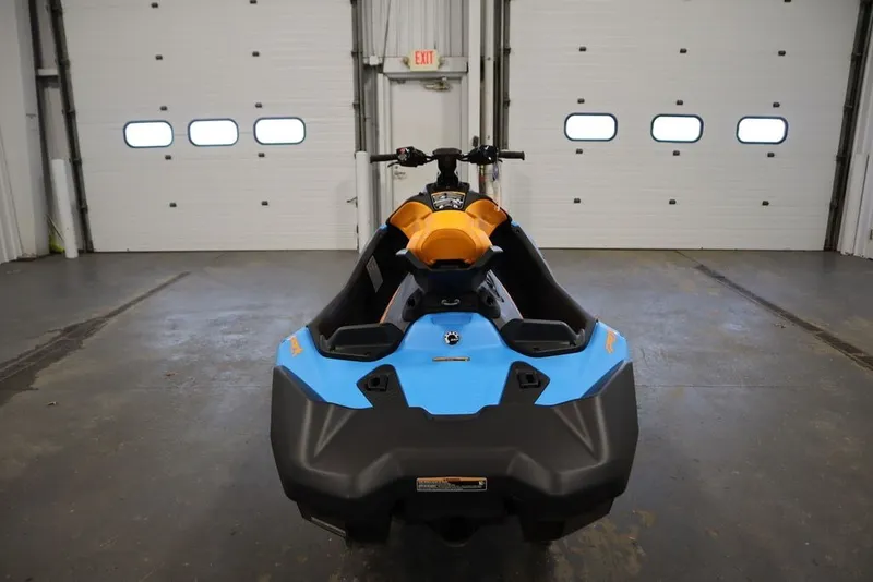 Slide: The Image of 2026 Sea-Doo Spark Trixx for 3 in a garage, showcasing vibrant design. - 8
