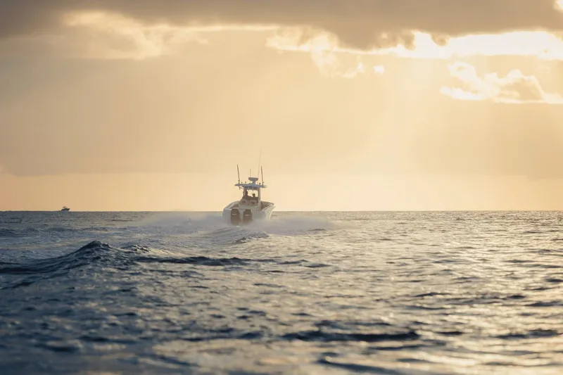Slide: The Image of Boston Whaler 280 Outrage on open sea at sunset. - 23