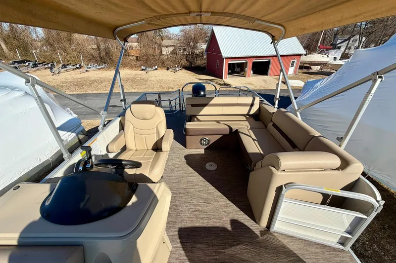 Slide: The Image of 2023 Godfrey Sweetwater 2286 SFL pontoon boat interior with beige seating and canopy. - 10