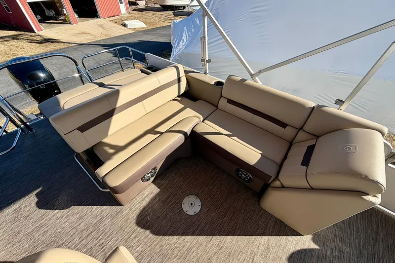 Slide: The Image of 2023 Godfrey Sweetwater 2286 SFL boat interior with beige seating and carpeted floor. - 15