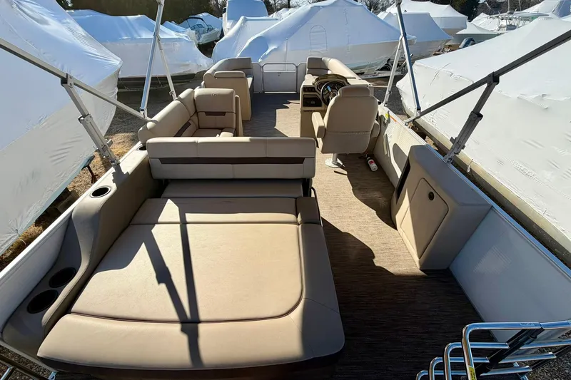 Slide: The Image of 2023 Godfrey Sweetwater 2286 SFL pontoon boat interior with beige seating and helm. - 16