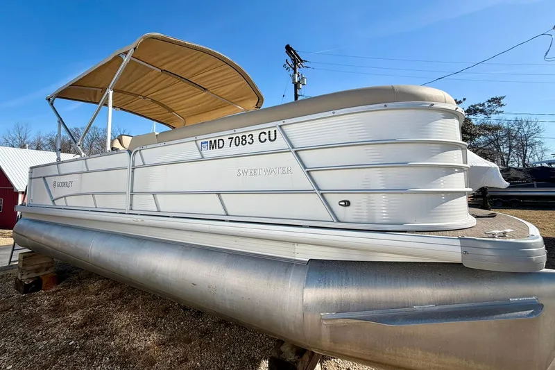 Slide: The Image of 2023 Godfrey Sweetwater 2286 SFL pontoon boat with canopy, parked outdoors. - 4