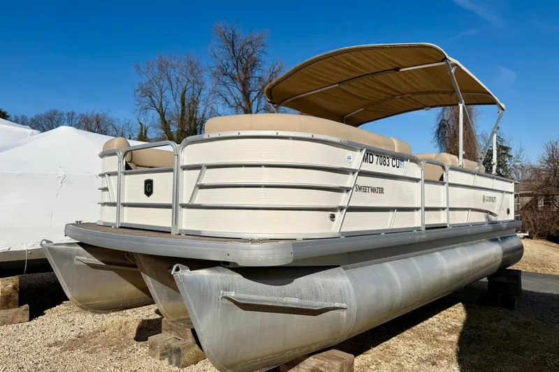 Slide: The Image of 2023 Godfrey Sweetwater 2286 SFL pontoon boat with canopy, parked on blocks. - 5