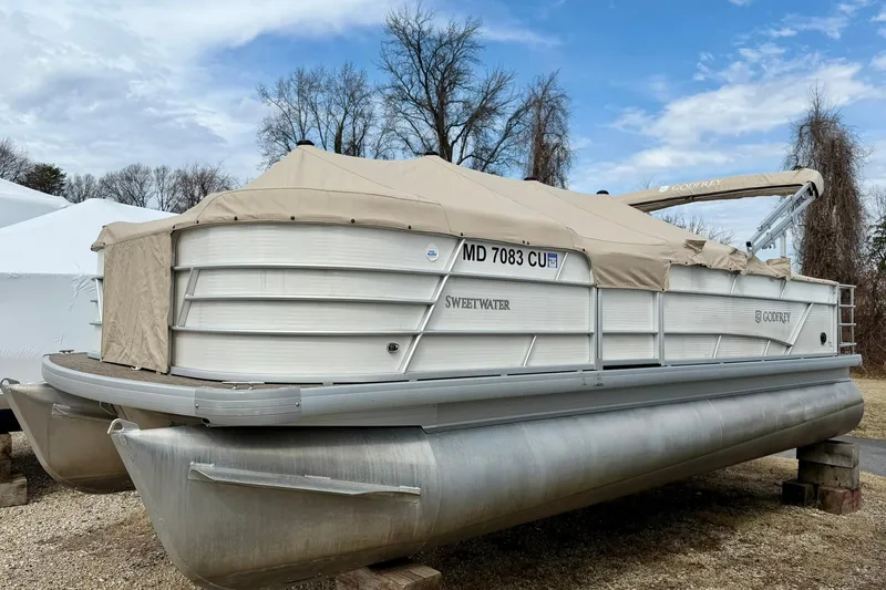 Slide: The Image of 2023 Godfrey Sweetwater 2286 SFL pontoon boat covered, parked on land. - 6