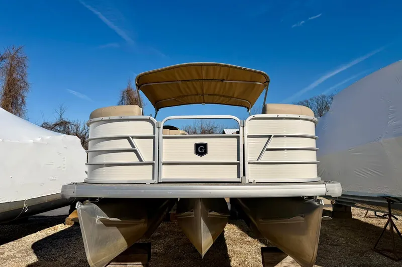 Slide: The Image of 2023 Godfrey Sweetwater 2286 SFL pontoon boat with canopy, displayed outdoors. - 7
