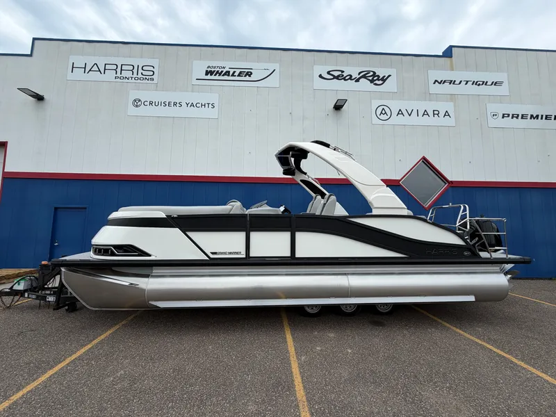Slide: The Image of 2026 Harris Grand Mariner 230 pontoon boat in front of a building. - 0