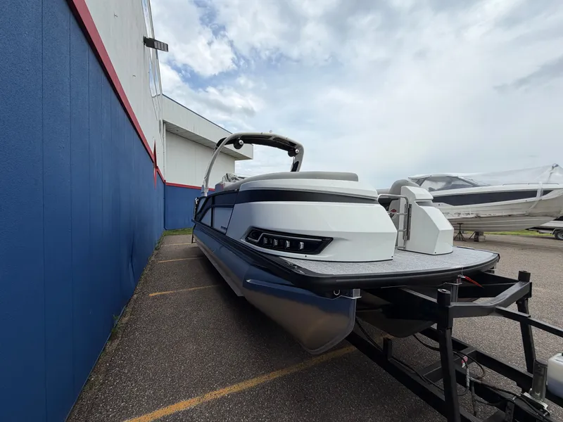 Slide: The Image of Harris Grand Mariner 230 boat, 2026 model, parked on a trailer. - 1
